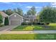 Inviting single-Gathering home with a well-kept lawn, featuring stone accents and a two-car garage at 114 Canoe Pole Ln, Mooresville, NC 28117