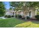 Charming single-story home featuring a stone facade, well-manicured lawn, and mature trees on a sunny day at 114 Canoe Pole Ln, Mooresville, NC 28117