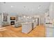 Open concept kitchen with island, stainless appliances, granite countertops, and views of the living area at 114 Canoe Pole Ln, Mooresville, NC 28117