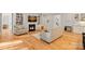 Inviting living area featuring hardwood floors, a fireplace, built-in bookshelves, and comfortable seating at 114 Canoe Pole Ln, Mooresville, NC 28117