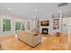 Bright living room with hardwood floors, built-in shelving, and a fireplace, perfect for relaxing and entertaining at 114 Canoe Pole Ln, Mooresville, NC 28117