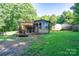 Lush backyard featuring a cozy back porch, storage shed, and ample green space at 121 C And C Ln, Mooresville, NC 28115