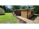 Charming home exterior showcasing the landscaped yard, wood paneling and stone foundation at 121 C And C Ln, Mooresville, NC 28115