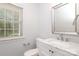 Neutral half bathroom with marble countertop vanity and window at 12321 Aquitaine St, Charlotte, NC 28277