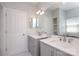 Bathroom featuring double sink vanity, lighting and large mirror at 12321 Aquitaine St, Charlotte, NC 28277