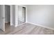 Bedroom featuring laminate floors and a closet with sliding mirror doors at 12321 Aquitaine St, Charlotte, NC 28277