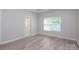 Bright bedroom with modern flooring and natural light from window at 12321 Aquitaine St, Charlotte, NC 28277