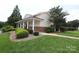 Community clubhouse with a red roof, white columns, brick accents, and mature landscaping for a welcoming atmosphere at 12321 Aquitaine St, Charlotte, NC 28277