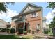 Charming two-story brick home with a well-manicured lawn and inviting entrance in a peaceful neighborhood at 12321 Aquitaine St, Charlotte, NC 28277