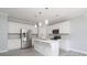 Elegant kitchen with white cabinets, modern stainless steel appliances, and pendant lighting at 12321 Aquitaine St, Charlotte, NC 28277