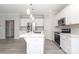 Bright kitchen with white cabinetry, stainless appliances, and large center island at 12321 Aquitaine St, Charlotte, NC 28277