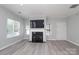 Cozy living room with a fireplace and contemporary flooring, bathed in natural light from multiple windows at 12321 Aquitaine St, Charlotte, NC 28277