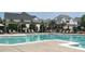 Community pool with several lounge chairs for relaxation, a pergola, and neighborhood homes in the background at 12321 Aquitaine St, Charlotte, NC 28277