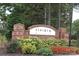 Riviera community sign with colorful accents and a brick base, set amidst lush landscaping and mature trees at 12321 Aquitaine St, Charlotte, NC 28277