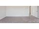 A bedroom featuring neutral walls, gray carpeting, and base trim at 135 Satchel Ct, Mooresville, NC 28115