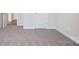 Second bedroom with plush carpeting, neutral walls and trim, and a glimpse of hall at 145 Satchel Ct, Mooresville, NC 28115