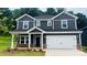 Two-story home with gray siding, white trim, a two-car garage, and a well-manicured lawn at 145 Satchel Ct, Mooresville, NC 28115