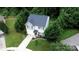 Aerial view of the property showcasing the lush landscaping and surrounding trees at 1548 Logan Patrick Ct, Gastonia, NC 28052