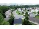 Aerial view featuring a residential area with houses and lush greenery throughout the neighborhood at 1548 Logan Patrick Ct, Gastonia, NC 28052