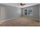 Bedroom with neutral carpet, ceiling fan and a double window allowing natural light at 1548 Logan Patrick Ct, Gastonia, NC 28052