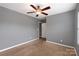 Bedroom featuring gray walls, carpeted floor and ceiling fan and a view into closet at 1548 Logan Patrick Ct, Gastonia, NC 28052