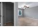 View of bedroom showing carpet, a ceiling fan, closet, and a window for natural light at 1548 Logan Patrick Ct, Gastonia, NC 28052