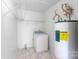 Bright laundry room with a washer and dryer hookup and water heater, and white wire shelving at 1548 Logan Patrick Ct, Gastonia, NC 28052