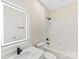 Bathroom with illuminated mirror, sleek vanity, and tiled tub-shower combo at 17136 Red Feather Dr, Charlotte, NC 28277