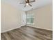 Bedroom with wood-look flooring, ceiling fan, and window with blinds at 17136 Red Feather Dr, Charlotte, NC 28277