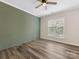 Bedroom features a decorative green accent wall and bright window at 17136 Red Feather Dr, Charlotte, NC 28277