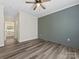 Bedroom with a decorative green accent wall, and view of the ensuite bathroom at 17136 Red Feather Dr, Charlotte, NC 28277