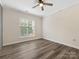 Bright bedroom features a ceiling fan and large window at 17136 Red Feather Dr, Charlotte, NC 28277