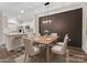 Dining area adjacent to the kitchen with modern lighting and stylish decorative wall panel at 17136 Red Feather Dr, Charlotte, NC 28277