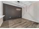 Dining area with modern lighting fixture and decorative wall panel next to the kitchen at 17136 Red Feather Dr, Charlotte, NC 28277
