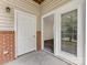 Exterior entrance featuring white doors, sidelight window, and partial brick facade at 17136 Red Feather Dr, Charlotte, NC 28277