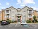 Apartment building exterior with private balconies, parking and manicured landscaping at 17136 Red Feather Dr, Charlotte, NC 28277