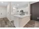 Contemporary kitchen features white cabinets, quartz countertops, and stainless steel appliances at 17136 Red Feather Dr, Charlotte, NC 28277