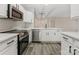 Modern kitchen with stainless steel appliances, white cabinetry, and sleek quartz countertops at 17136 Red Feather Dr, Charlotte, NC 28277