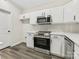 Stylish kitchen with white cabinetry, stainless steel appliances, and modern subway tile backsplash at 17136 Red Feather Dr, Charlotte, NC 28277