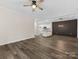 Open-concept living room with stylish accent wall and view into the kitchen at 17136 Red Feather Dr, Charlotte, NC 28277