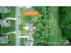 Expansive aerial view of a home with lush landscaping, mature trees, and a well-maintained lawn at 172 Hunters Hill Dr, Statesville, NC 28677