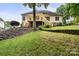 Spacious backyard with a tiered retaining wall and a wooden deck with stairs at 172 Hunters Hill Dr, Statesville, NC 28677