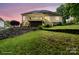 Spacious backyard with a tiered retaining wall and a wooden deck with stairs at 172 Hunters Hill Dr, Statesville, NC 28677