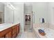 Bright bathroom with double sinks, a walk-in closet, and a soaking tub at 172 Hunters Hill Dr, Statesville, NC 28677