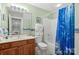 Well-lit bathroom featuring a cherry wood vanity and blue accents throughout at 172 Hunters Hill Dr, Statesville, NC 28677