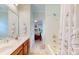 Bright bathroom featuring double sinks, a walk-in shower, and tile flooring at 172 Hunters Hill Dr, Statesville, NC 28677