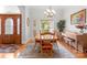 Elegant dining room featuring a large window, chandelier lighting and a decorative wooden door at 172 Hunters Hill Dr, Statesville, NC 28677