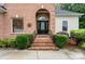Inviting brick entryway with a decorative front door, elegant iron railings, and lush landscaping at 172 Hunters Hill Dr, Statesville, NC 28677