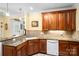 Spacious kitchen with granite countertops, wooden cabinets, and a white dishwasher at 172 Hunters Hill Dr, Statesville, NC 28677