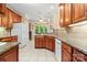 Open kitchen with granite countertops, tile floors, wooden cabinets and white refrigerator at 172 Hunters Hill Dr, Statesville, NC 28677